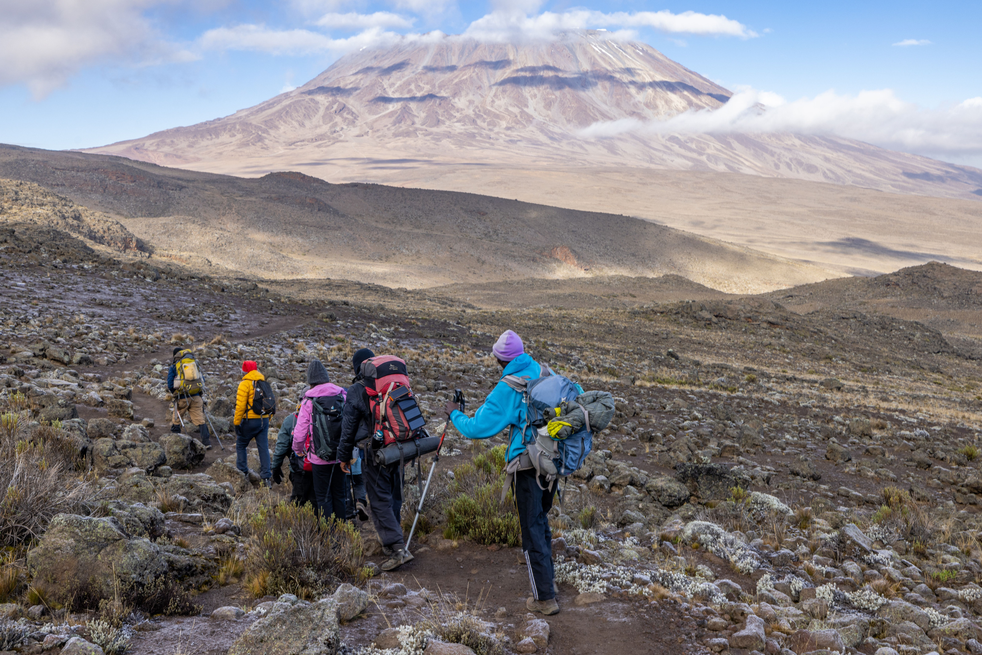 Hikers make their way along a rugged trail on the upper slopes of Kilimanjaro.