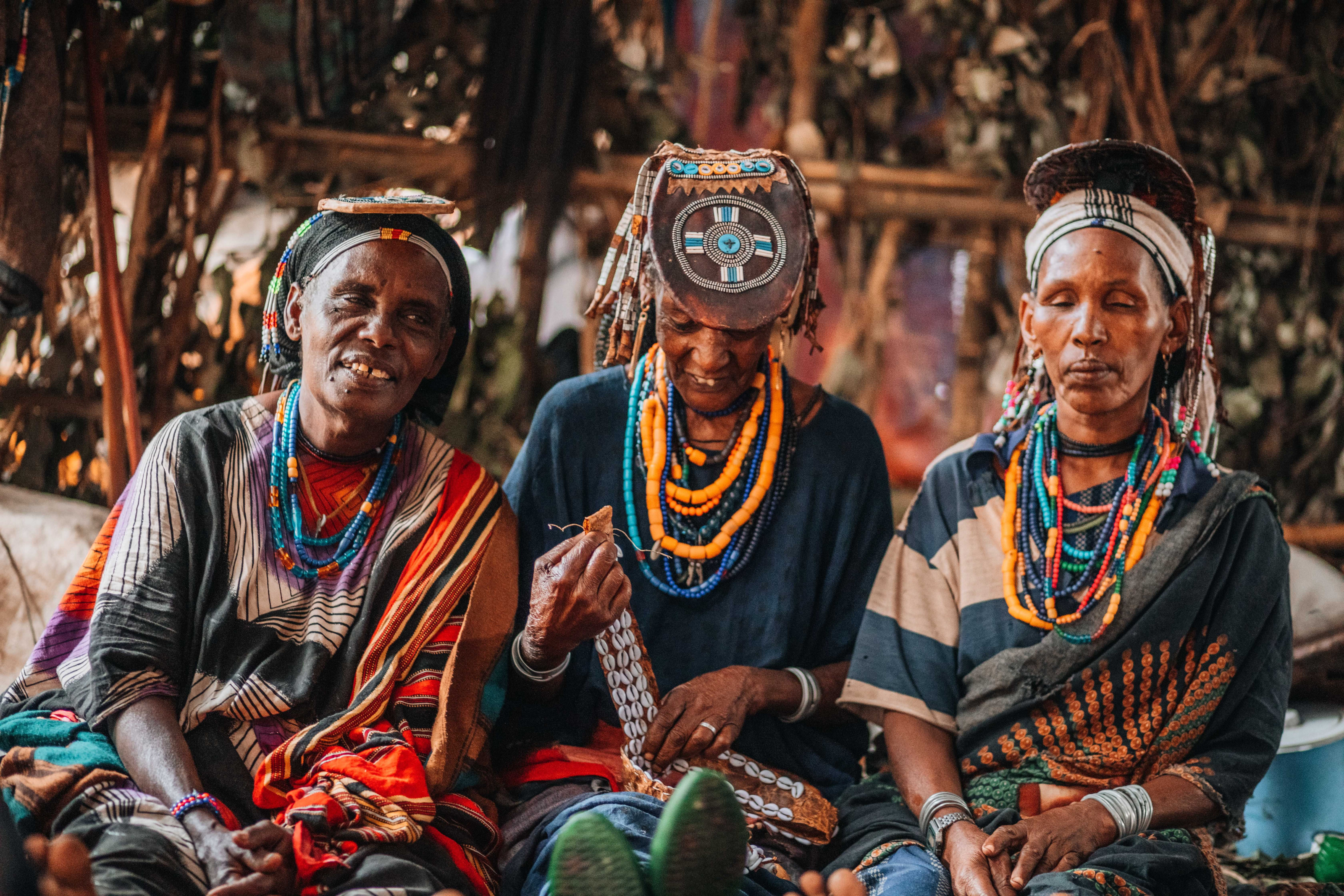 A group of tribal community members in Ethiopia wear traditional beaded jewelry and clothing.