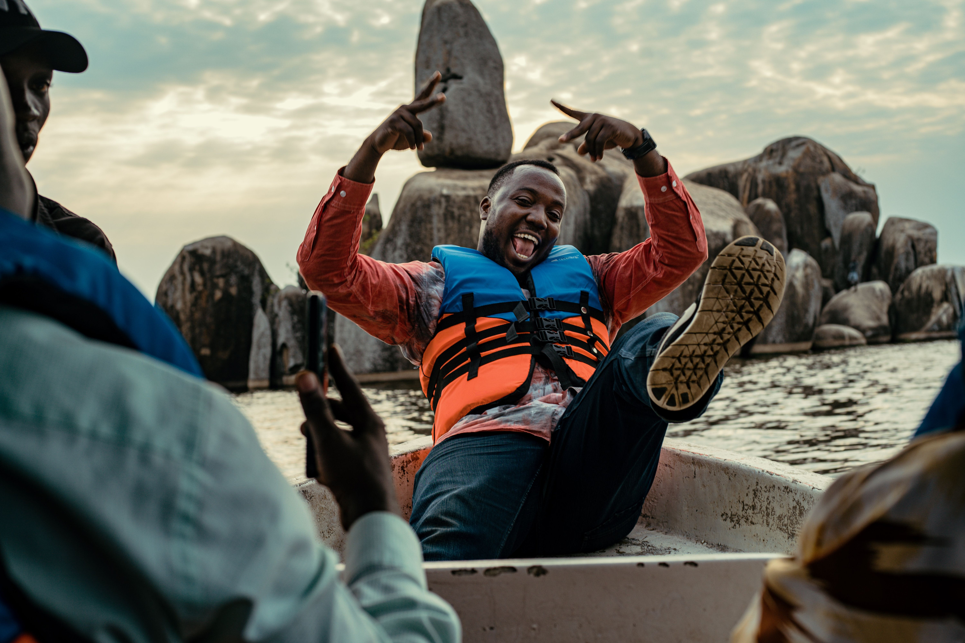 A group enjoying a boat ride across the open water of Lake Victoria.
