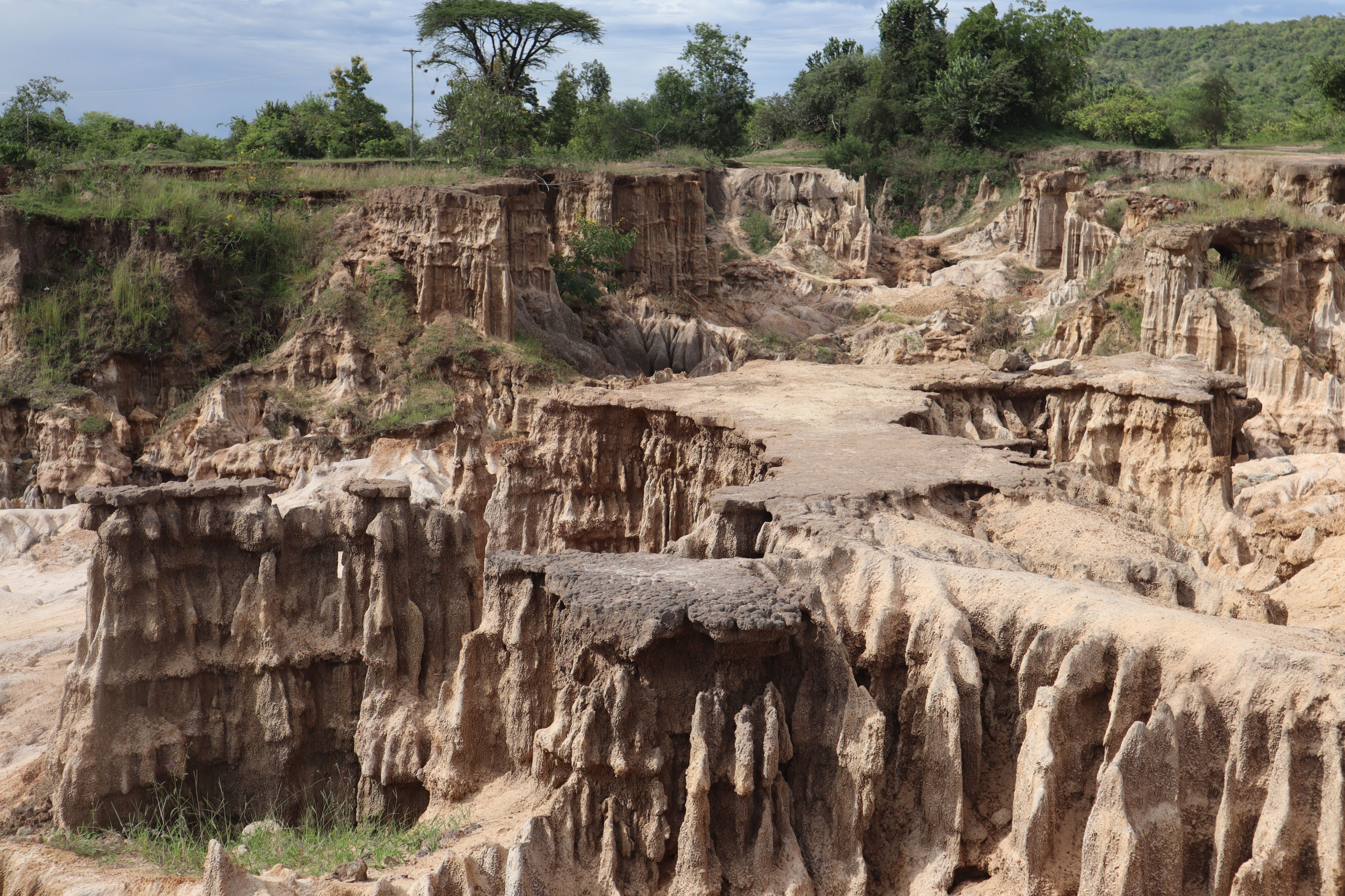 Eroded volcanic rock formations rise from the highland terrain of Kenya's Rift Valley.